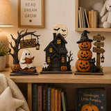 The Boo Crew Halloween figurines arranged on a bookshelf next to spooky-themed children's books and a 'Read Dream Grow' sign.